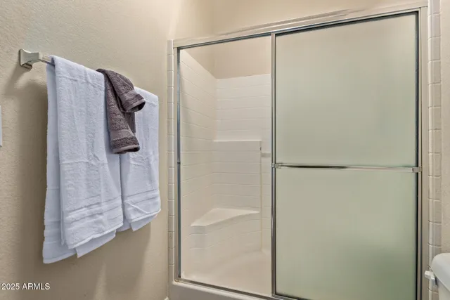 a bathroom with a glass shower door