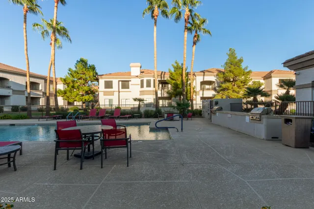 a view of a patio with table and chairs potted plants