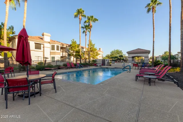 a swimming pool with outdoor seating