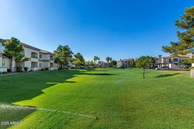 a view of building with garden and trees
