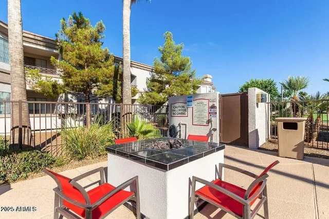 a view of a house with a swimming pool and a chairs