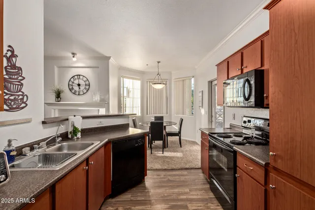 a kitchen with stainless steel appliances a sink stove and refrigerator