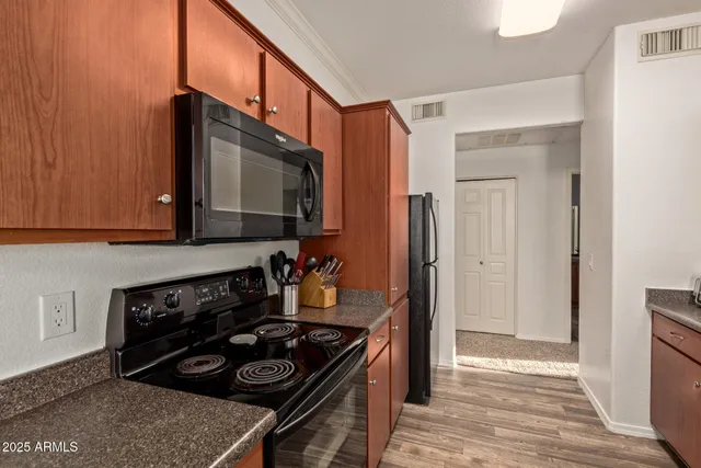 a kitchen with stainless steel appliances granite countertop a stove and a microwave