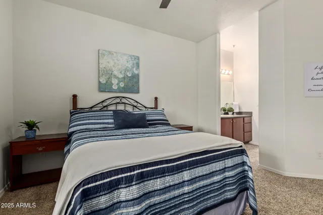 a bedroom with a bed and painting on the wall