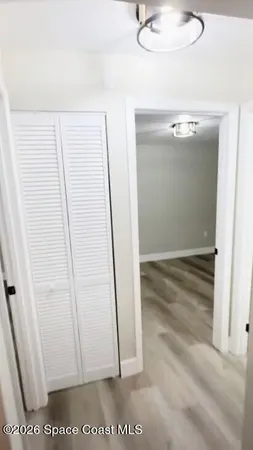a bedroom with a bed and a night stand