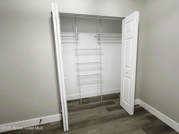 a view of wooden door and brick wall