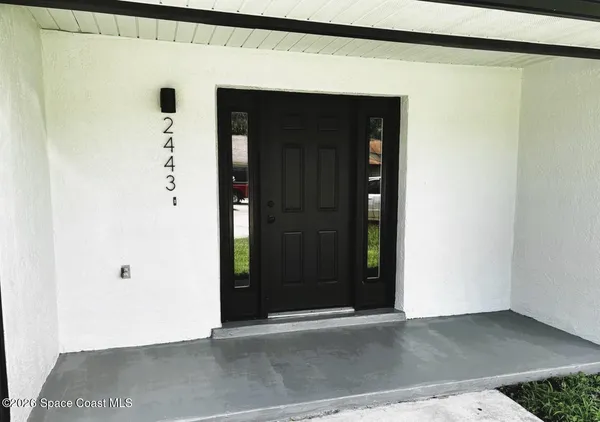 a kitchen with granite countertop a refrigerator stove top oven and sink
