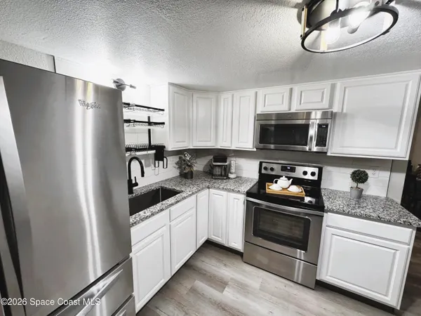 a kitchen with a sink and a stove top oven