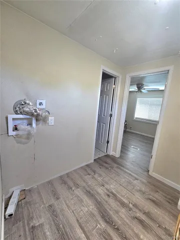 an empty room with wooden floor and closet