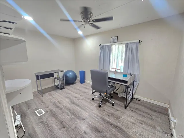 a view of a workspace with furniture and a window