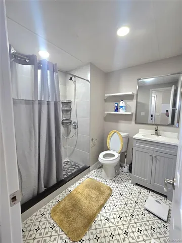a bathroom with a toilet a sink and a mirror
