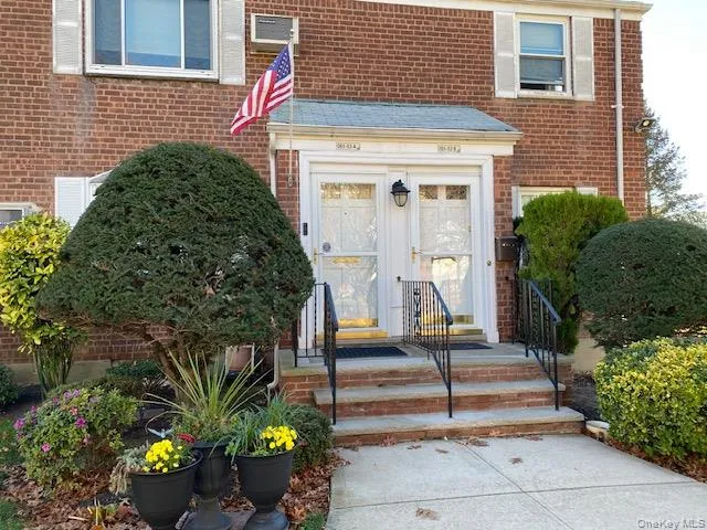 a front view of a house with outdoor seating and plants