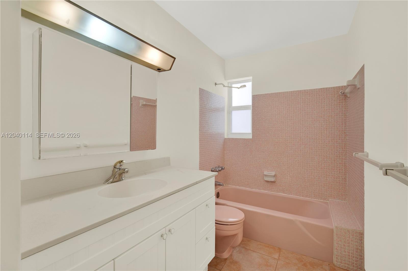 10435 Southwest 96th Street Miami, FL 33176 - Photo 19 of 44 Hallway bathroom with the original pink tub, toilet and tile all in excellent condition