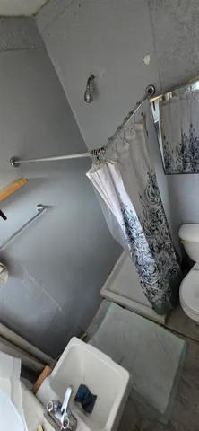 a bathroom with a toilet and a shower