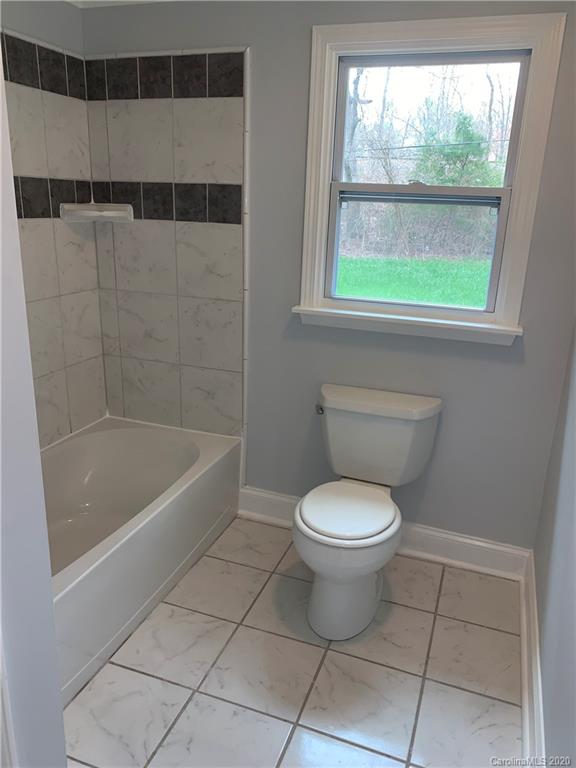 4477 Cureton Ferry Road Catawba, SC 29704 - Photo 12 of 20 a bathroom with a toilet a sink and a shower