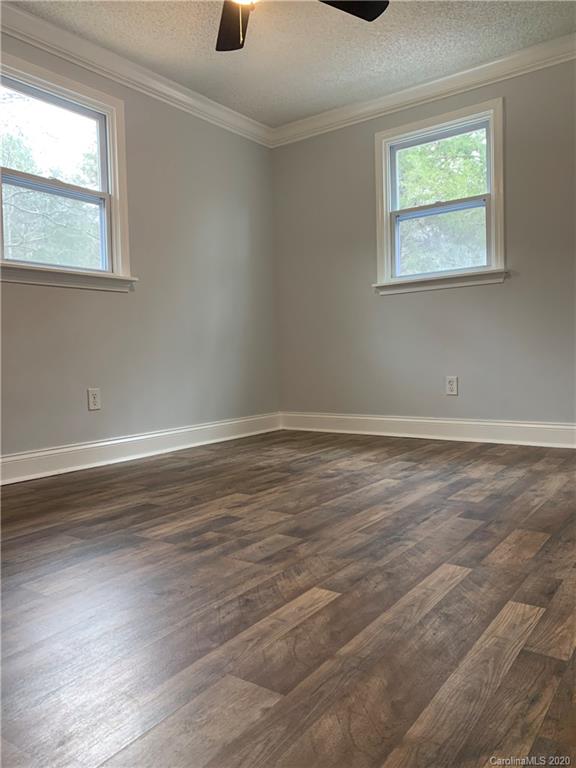 4477 Cureton Ferry Road Catawba, SC 29704 - Photo 18 of 20 a view of an empty room with wooden floor and a window