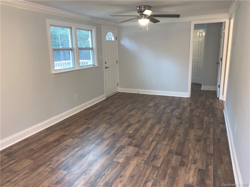 4477 Cureton Ferry Road Catawba, SC 29704 - Photo 6 of 20 an empty room with wooden floor fan and windows