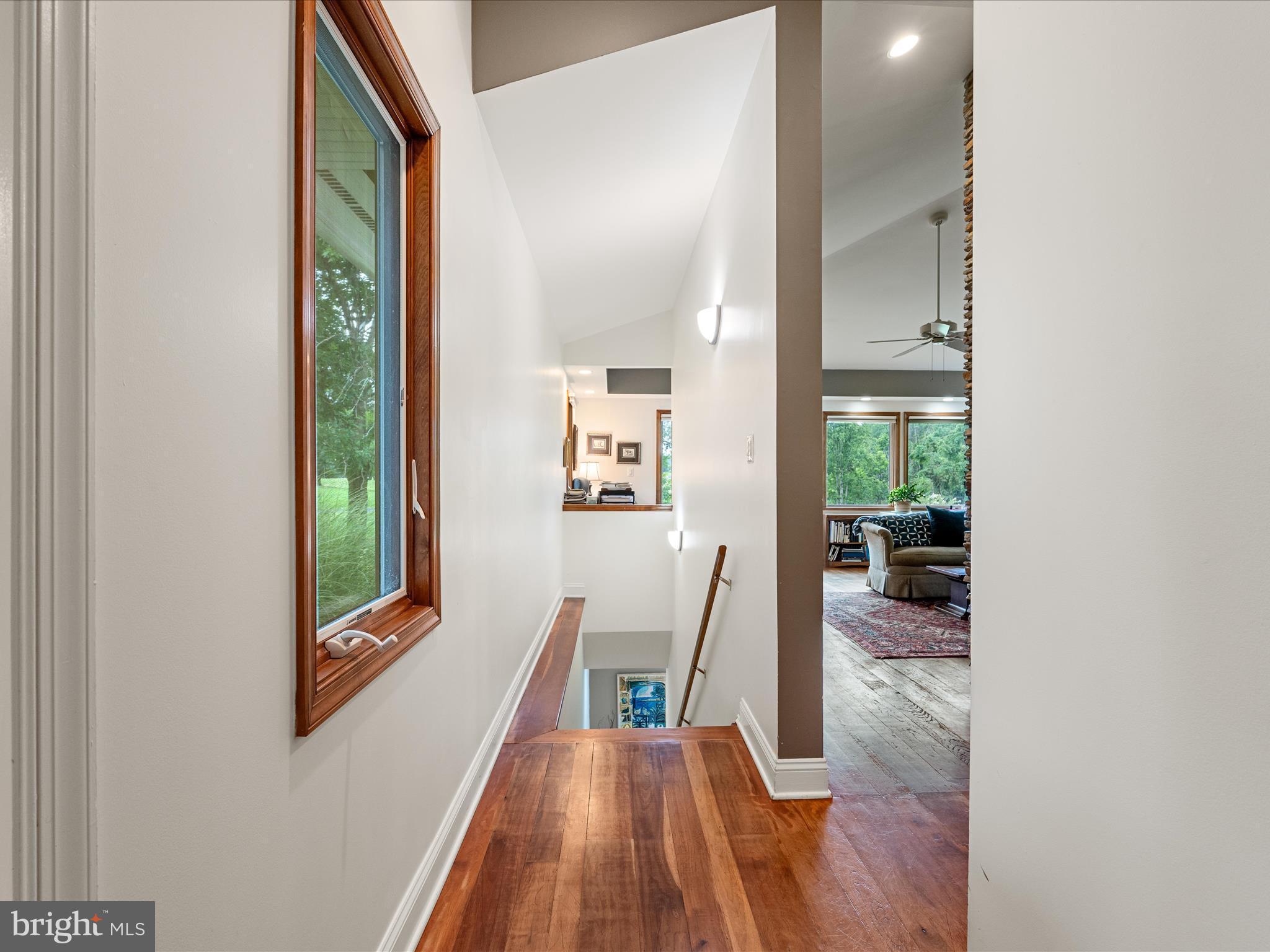 3959 Cobbler Mountain Road Delaplane, VA 20144 - Photo 52 of 106 a view of a hallway with wooden floor and furniture