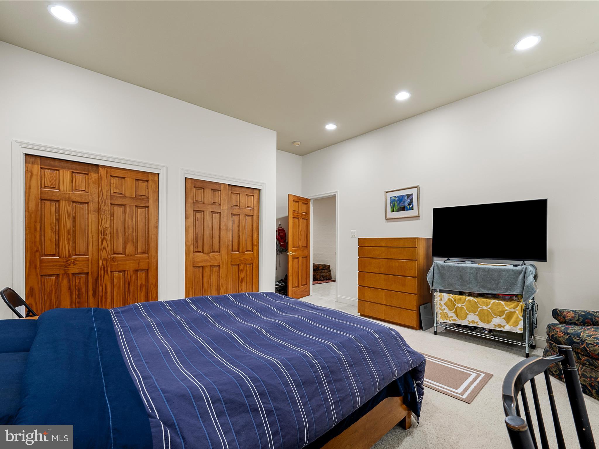 3959 Cobbler Mountain Road Delaplane, VA 20144 - Photo 58 of 106 a bedroom with a bed and a television