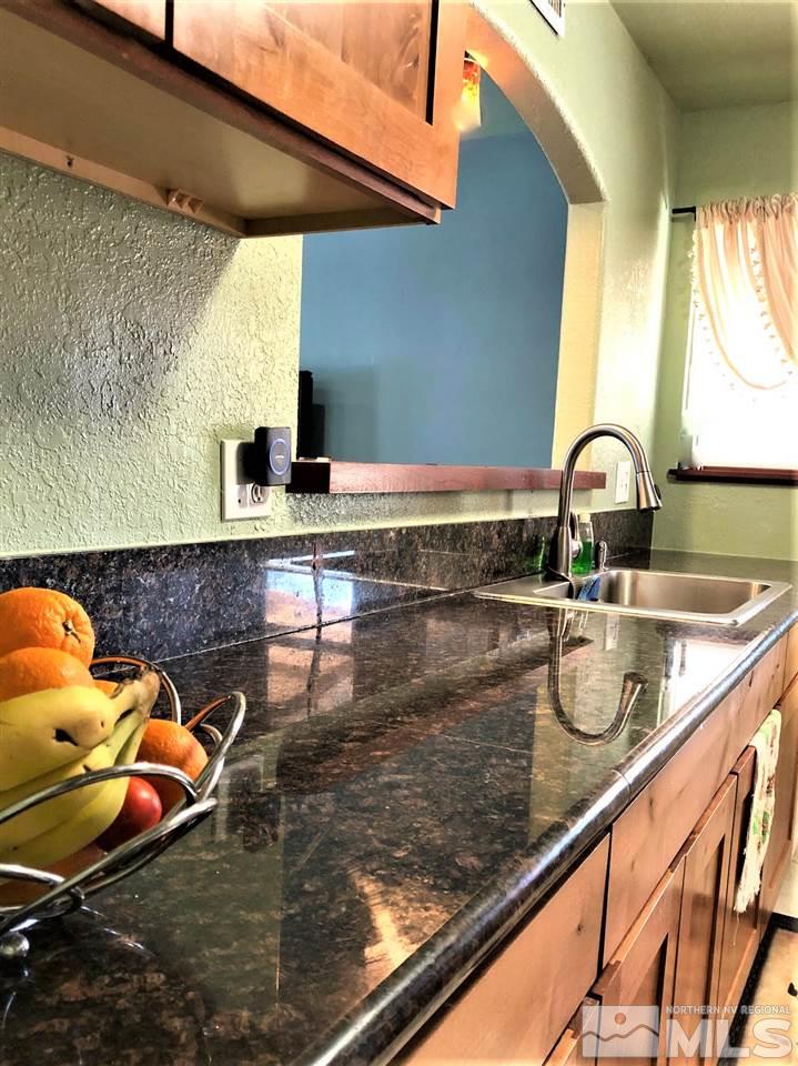 5220 Ural Street Reno, NV 89506 - Photo 6 of 19 a kitchen with a sink and a counter top space