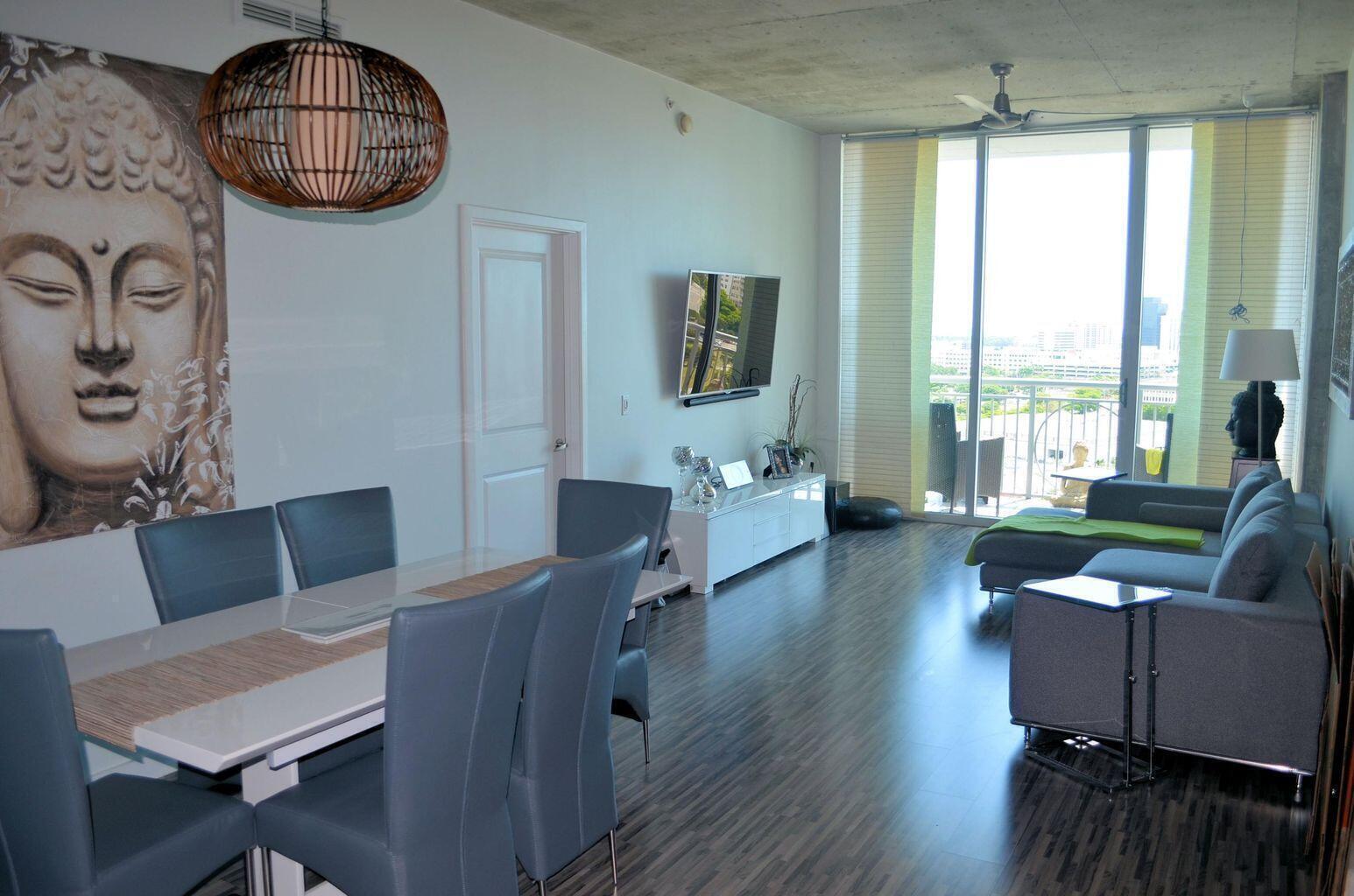 300 South Australian Avenue, Unit 1504 West Palm Beach, FL 33401 - Photo 15 of 27 a living room with furniture and a floor to ceiling window