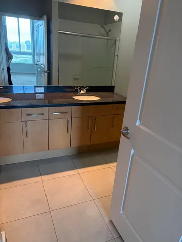 a view of kitchen with granite countertop cabinets