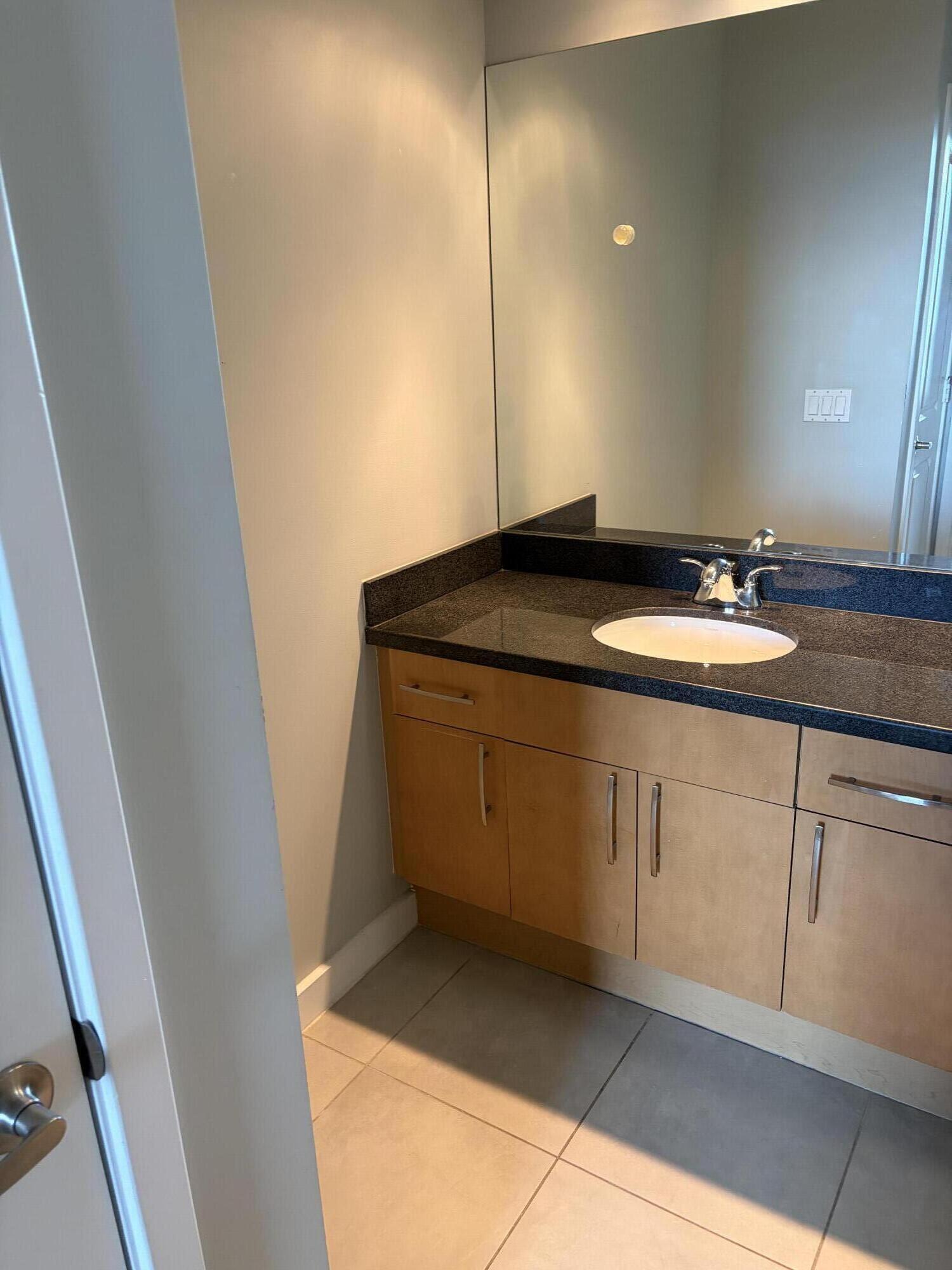 300 South Australian Avenue, Unit 1504 West Palm Beach, FL 33401 - Photo 19 of 27 a bathroom with a sink and vanity