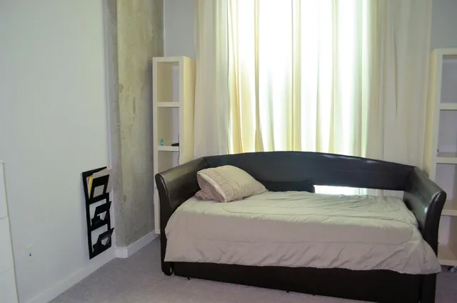 a bedroom with a bed and a window