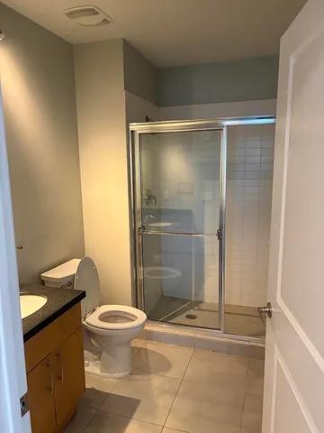 a bathroom with a toilet and a shower