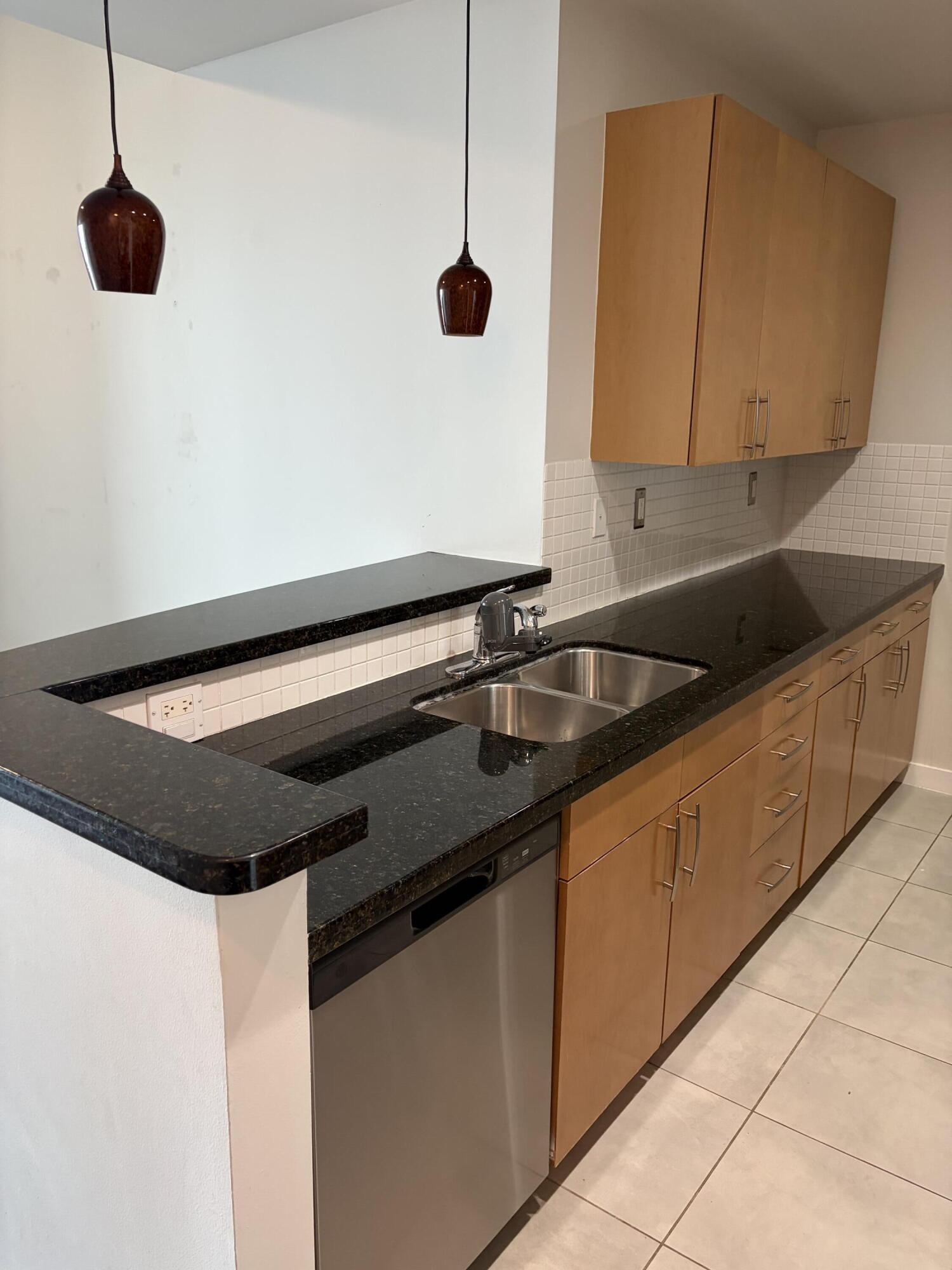 300 South Australian Avenue, Unit 1504 West Palm Beach, FL 33401 - Photo 24 of 27 a kitchen with a sink and a wooden floor