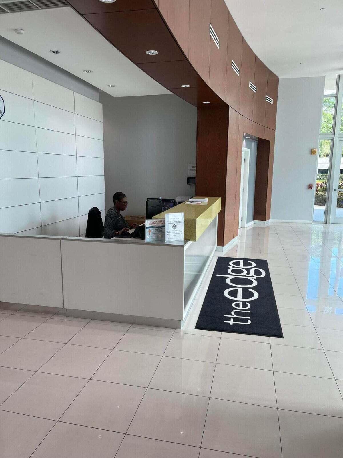 300 South Australian Avenue, Unit 1504 West Palm Beach, FL 33401 - Photo 4 of 27 a room with a couch a rug and a stove top oven