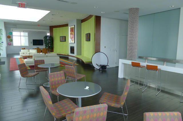 300 South Australian Avenue, Unit 1504 West Palm Beach, FL 33401 - Photo 7 of 27 a dining room with furniture a rug and wooden floor