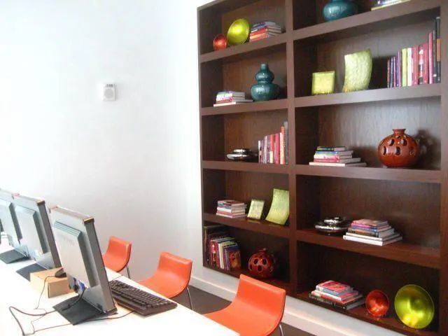a living room with lots of books and knick knacks on it