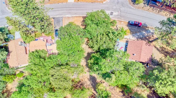 an aerial view of a house with a yard and garden in back