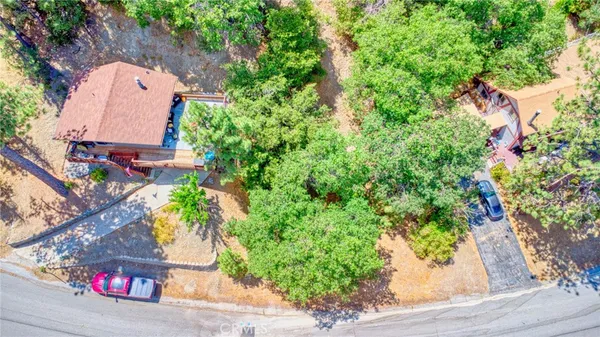 an aerial view of a house with a yard and garden