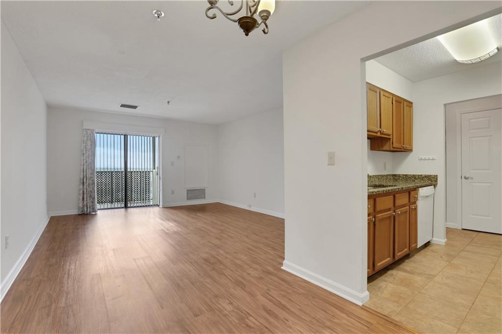 300 Johnson Ferry Road, Unit B1002 Sandy Springs, GA 30328 - Photo 12 of 26 an empty room with wooden floor cabinet and windows