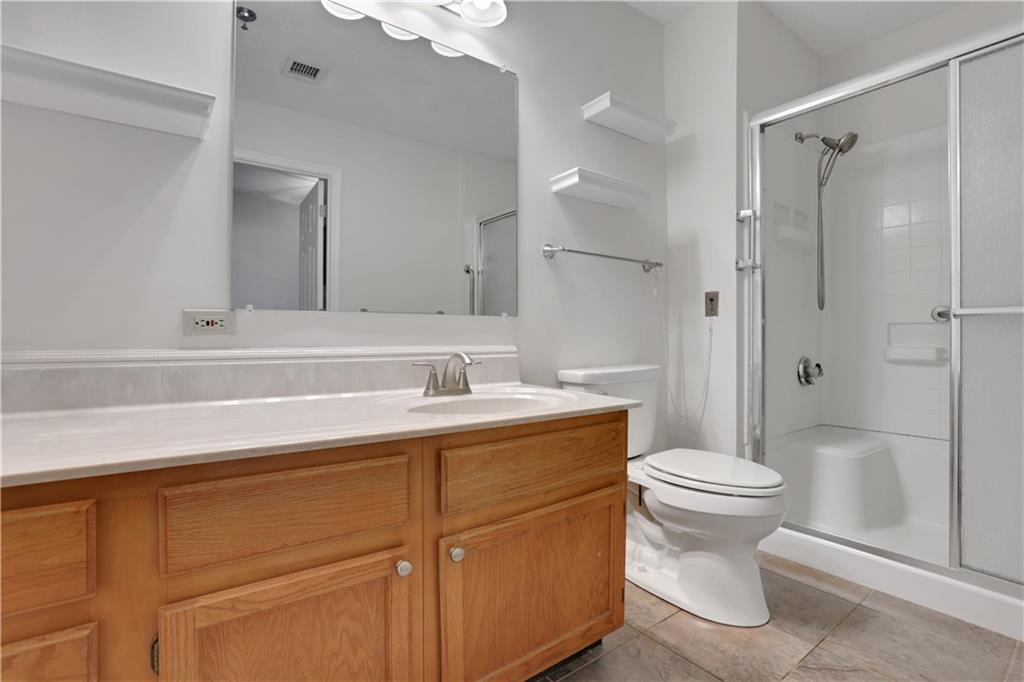 300 Johnson Ferry Road, Unit B1002 Sandy Springs, GA 30328 - Photo 18 of 26 a bathroom with a sink toilet and shower