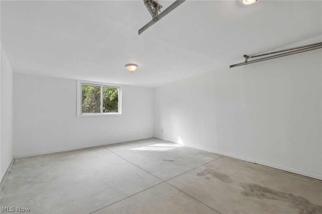 4188 Manchester Road Perry, OH 44081 - Photo 30 of 41 Poured concrete flooring, white painted walls, single window, and flush mount ceiling lights