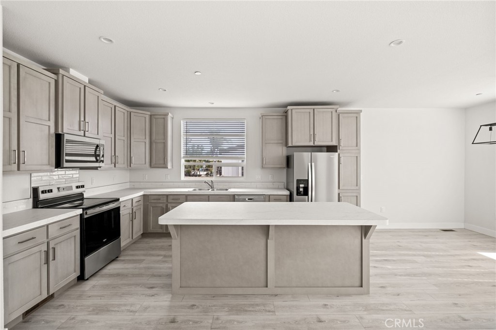 33064 Willard Street Winchester, CA 92596 - Photo 14 of 34 a large kitchen with stainless steel appliances granite countertop a stove a sink dishwasher and a refrigerator