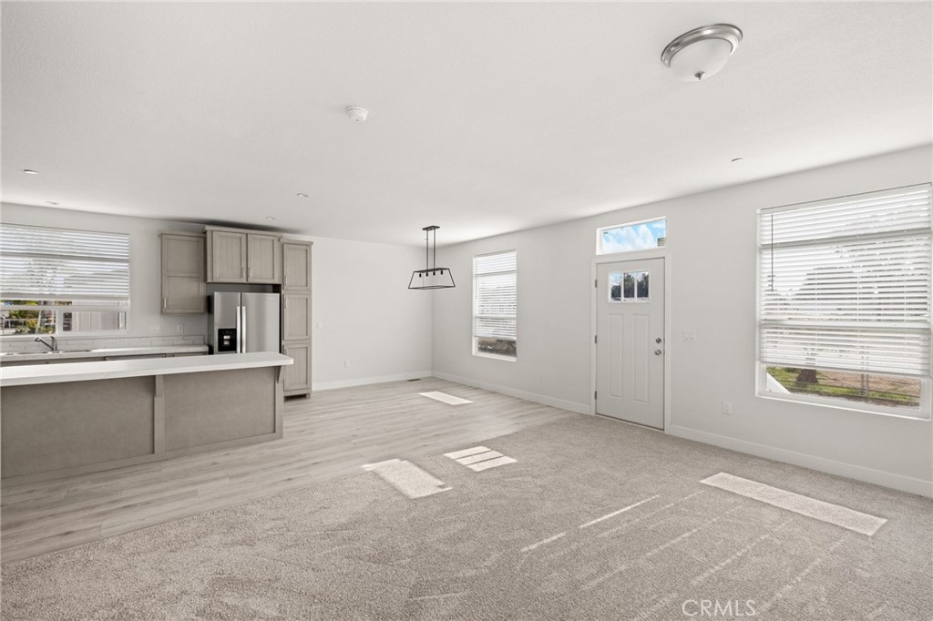 33064 Willard Street Winchester, CA 92596 - Photo 21 of 34 a view of a kitchen with a sink and dishwasher a refrigerator with white cabinets