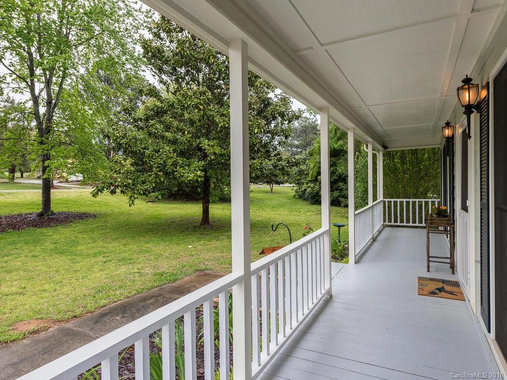 1527 Cobblestone Court, Unit 27A Fort Mill, SC 29708 - Photo 2 of 30 a view of a porch with wooden floor next to a yard