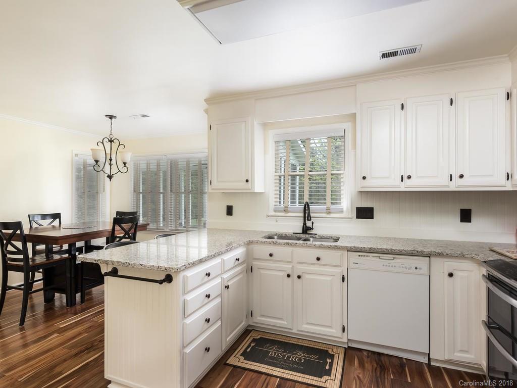 1527 Cobblestone Court, Unit 27A Fort Mill, SC 29708 - Photo 13 of 30 a kitchen with granite countertop a sink stove and cabinets