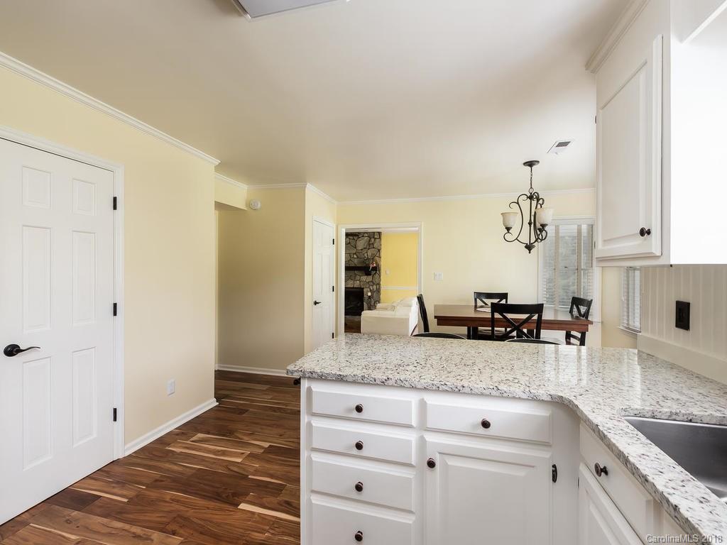 1527 Cobblestone Court, Unit 27A Fort Mill, SC 29708 - Photo 15 of 30 a kitchen with granite countertop a sink and cabinets