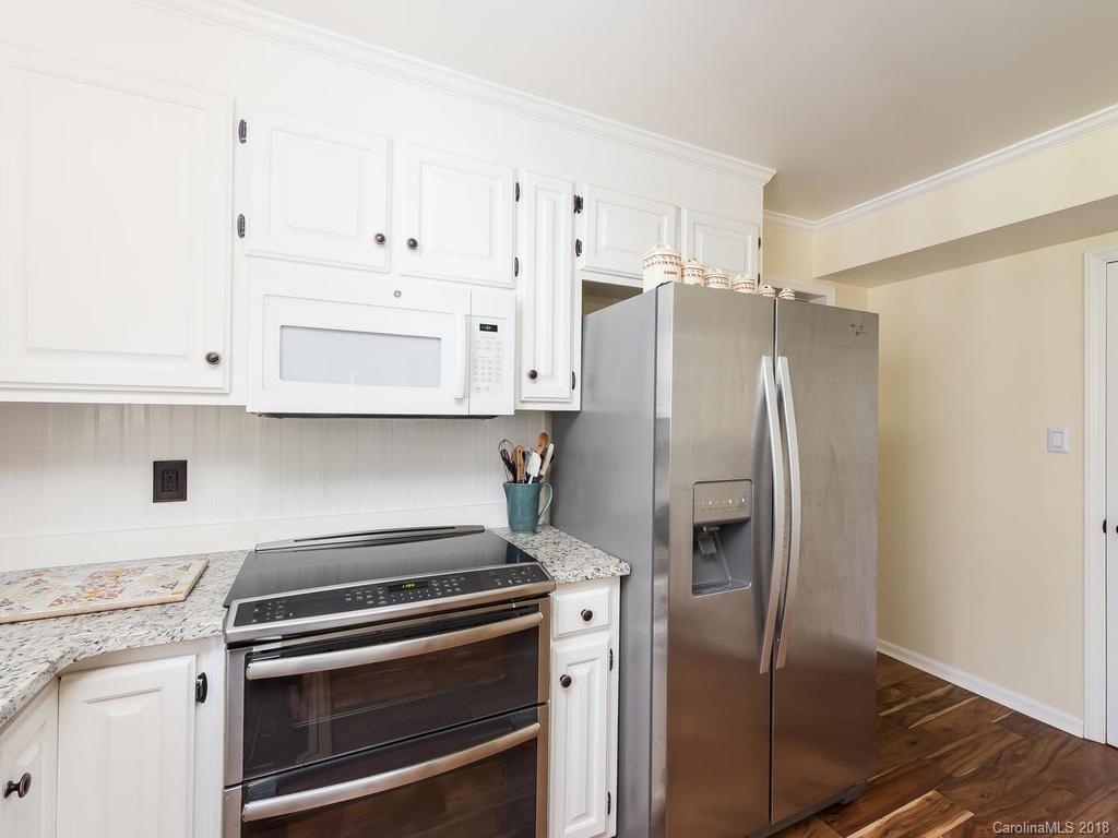 1527 Cobblestone Court, Unit 27A Fort Mill, SC 29708 - Photo 16 of 30 a kitchen with stainless steel appliances white cabinets and a stove