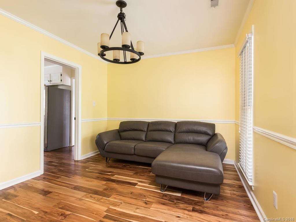 1527 Cobblestone Court, Unit 27A Fort Mill, SC 29708 - Photo 18 of 30 a living room with couches a flat screen tv and a table with wooden floor