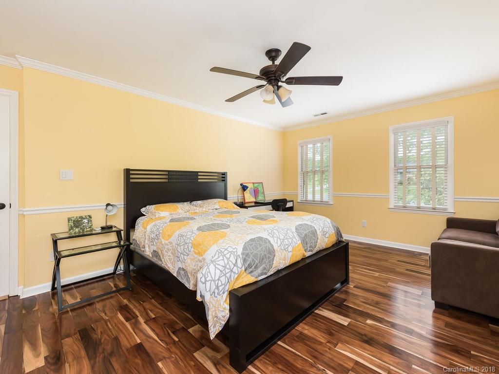 1527 Cobblestone Court, Unit 27A Fort Mill, SC 29708 - Photo 20 of 30 a bedroom with a bed and wooden floor