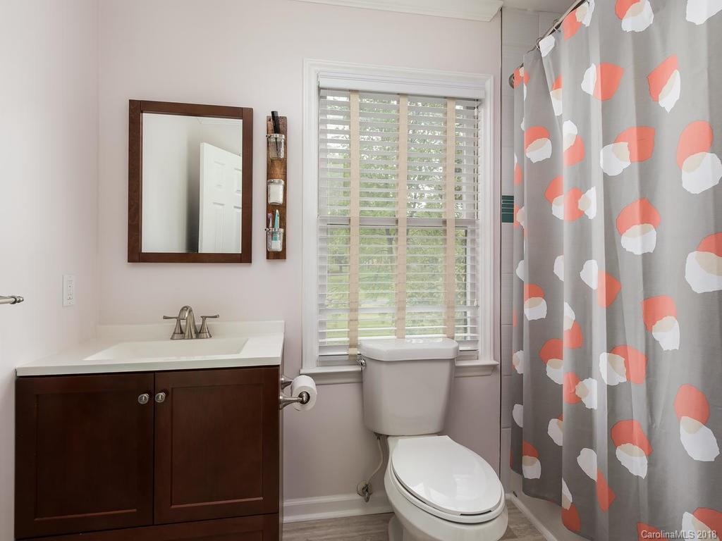 1527 Cobblestone Court, Unit 27A Fort Mill, SC 29708 - Photo 24 of 30 a bathroom with a toilet a sink and a mirror