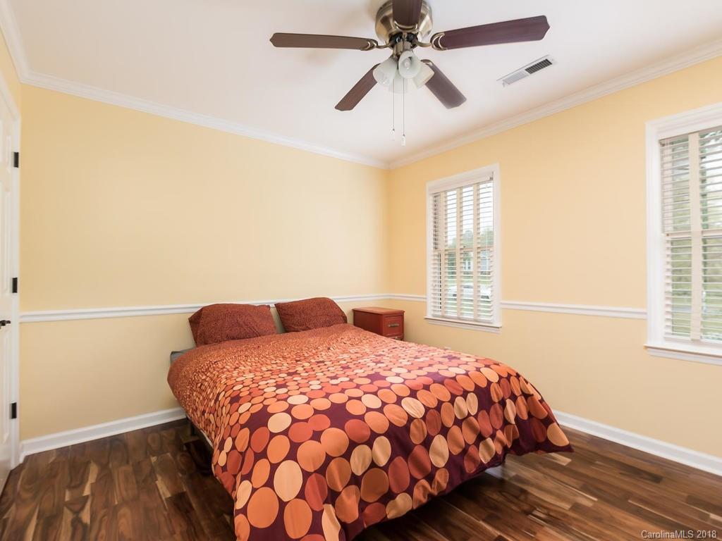 1527 Cobblestone Court, Unit 27A Fort Mill, SC 29708 - Photo 25 of 30 a bedroom with a bed and wooden floor