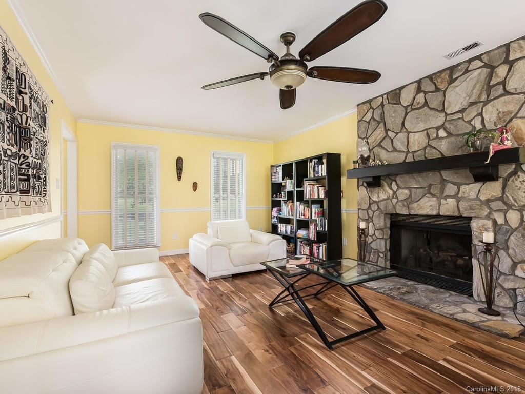 1527 Cobblestone Court, Unit 27A Fort Mill, SC 29708 - Photo 7 of 30 a living room with furniture a flat screen tv and a fireplace