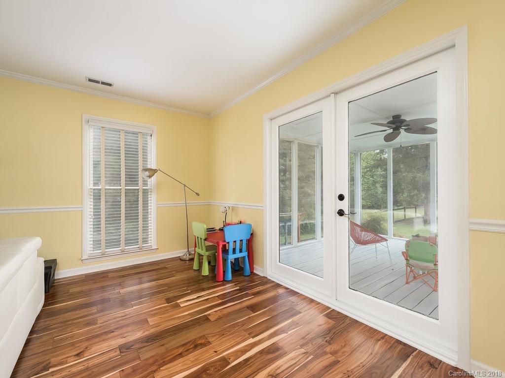 1527 Cobblestone Court, Unit 27A Fort Mill, SC 29708 - Photo 9 of 30 a view of an empty room with wooden floor and a window